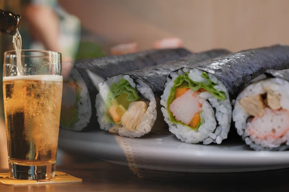 Glass of beer with sushi on a plate